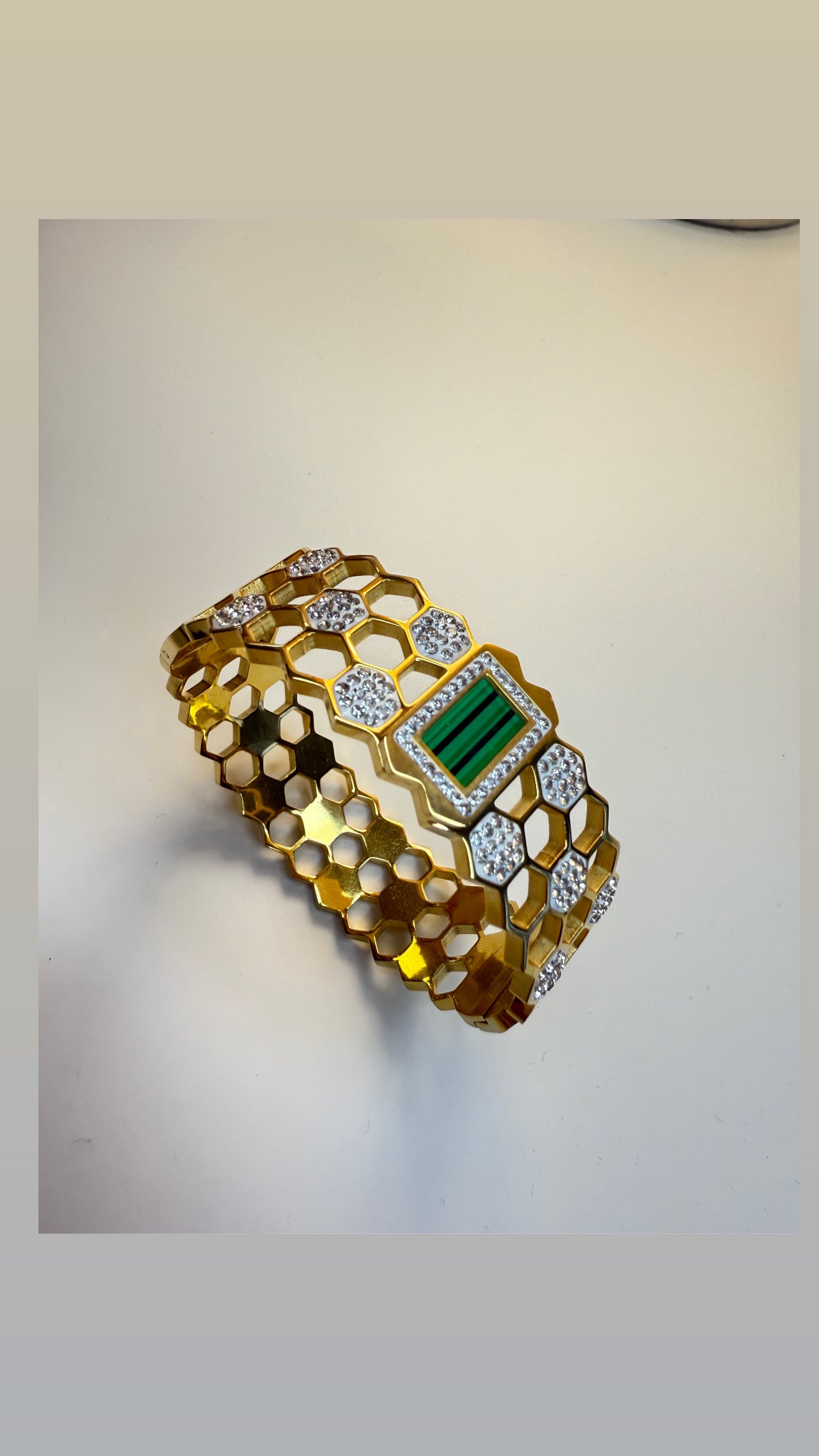 Elegant golden bangle with greenstone